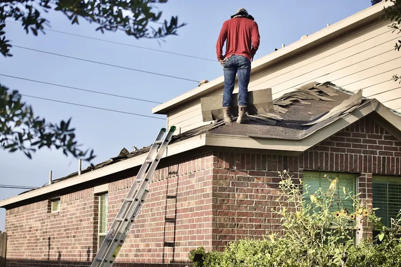 Professional roofer working on a residential roof in Bangor
